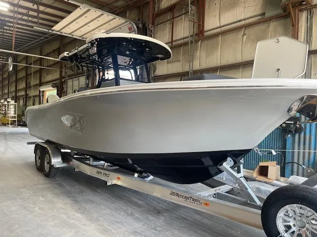 Slide: The Image of 2025 Sea Pro 292 boat on trailer in warehouse setting. - 2