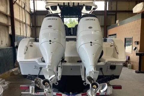 Slide: The Image of 2025 Sea Pro 292 boat with dual 300 horsepower engines in a warehouse. - 4