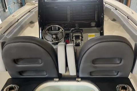 Slide: The Image of 2025 Sea Pro 292 boat interior with dual seats and steering console. - 6