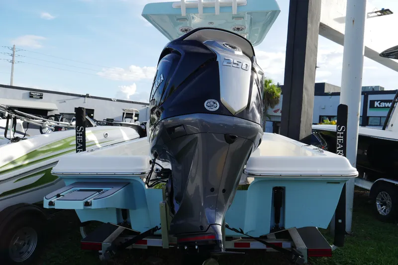 Slide: The Image of 2025 ShearWater 23LTZ boat with Yamaha 250 engine, displayed outdoors. - 2