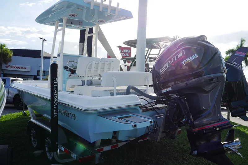 Slide: The Image of 2025 ShearWater 23LTZ boat with Yamaha engine displayed outdoors. - 3