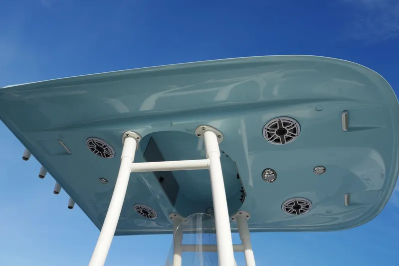 Slide: The Image of 2025 ShearWater 23LTZ boat top view with speakers against blue sky. - 8