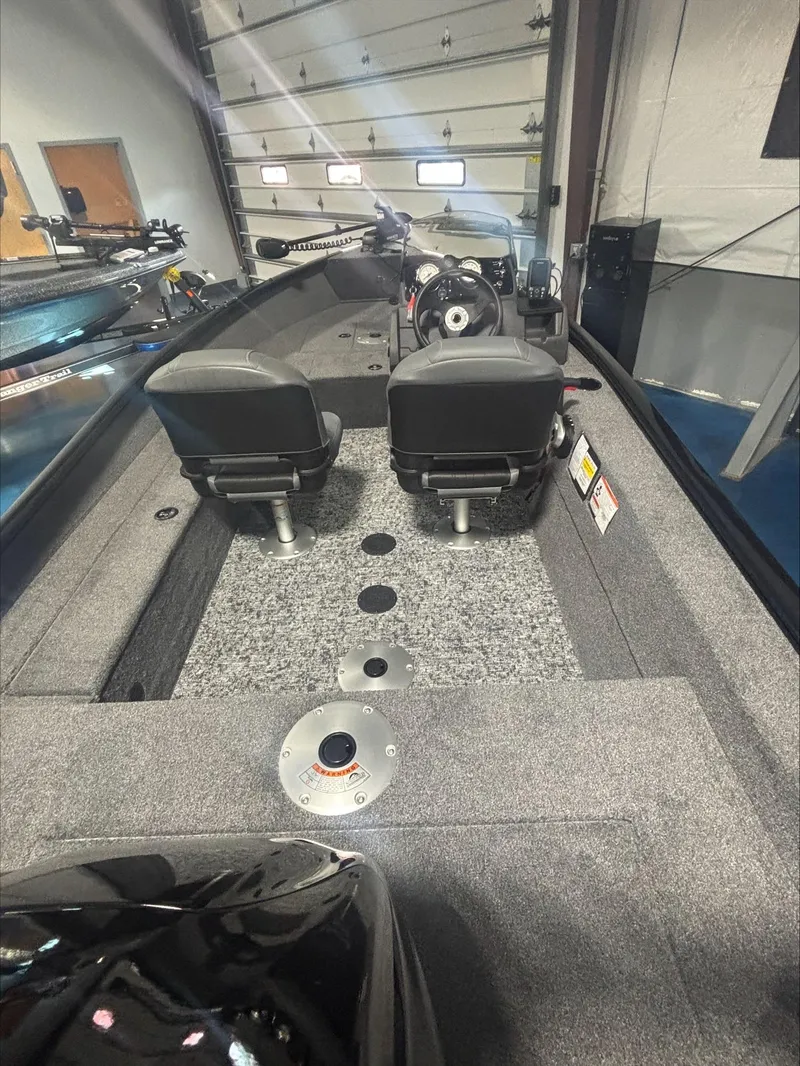Slide: The Image of 2025 Tracker SG V16 SC boat interior with dual seats and modern design. - 2