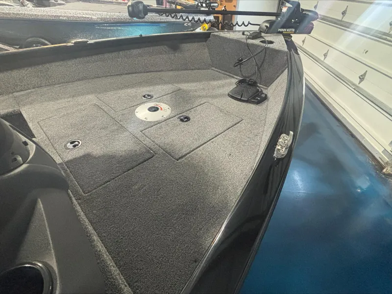 Slide: The Image of 2025 Tracker SG V16 SC boat interior with carpeted deck and storage compartments. - 6