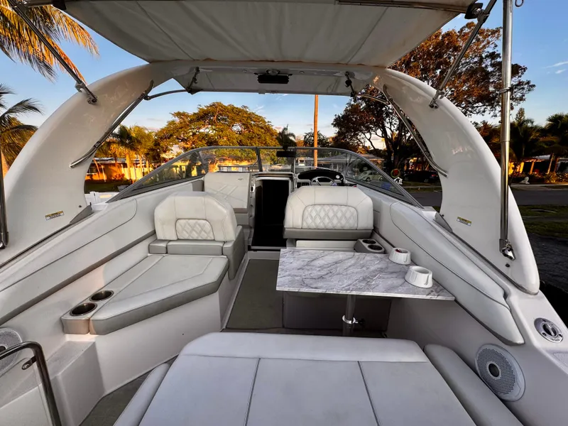 Slide: The Image of 2020 Regal 26XO boat interior with elegant seating and table, showcasing luxury design. - 13