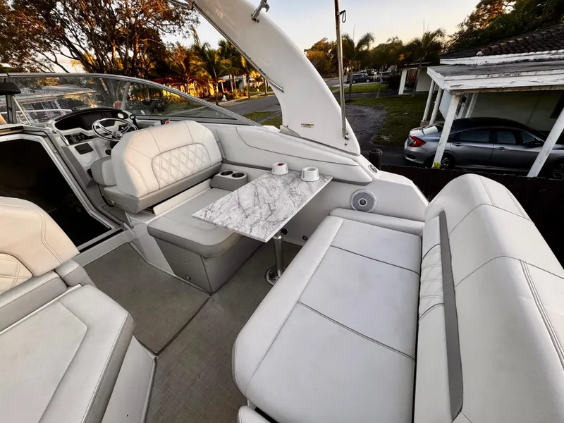 Slide: The Image of 2020 Regal 26XO boat interior with white seating and marble table. - 15