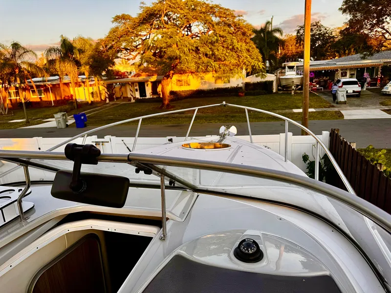 Slide: The Image of 2020 Regal 26XO boat docked in a residential area at sunset. - 25