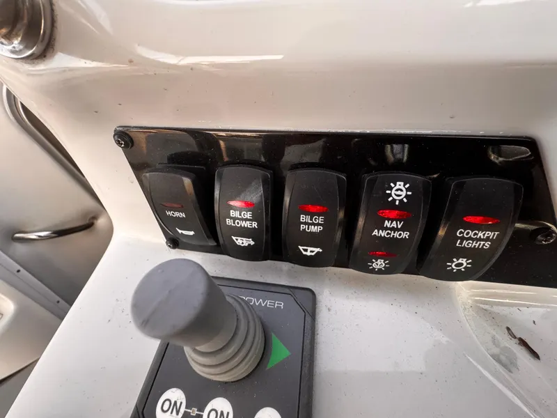 Slide: The Image of Control panel of a 2020 Regal 26XO boat with various switches and joystick. - 34