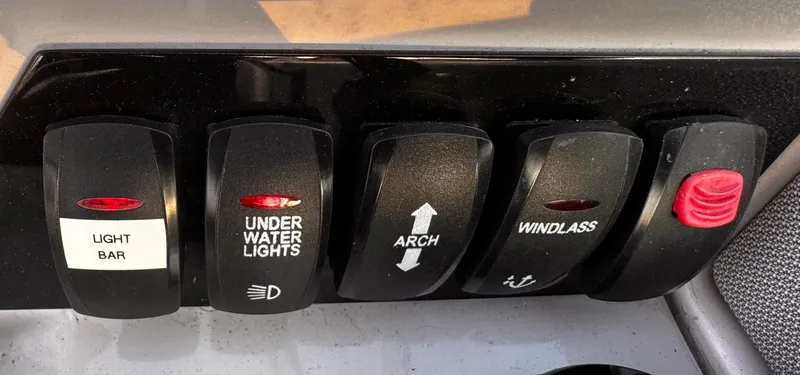 Slide: The Image of Control panel switches on a 2020 Regal 26XO boat dashboard. - 35