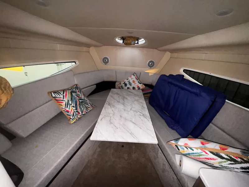 Slide: The Image of 2020 Regal 26XO boat interior with marble table and colorful cushions. - 45