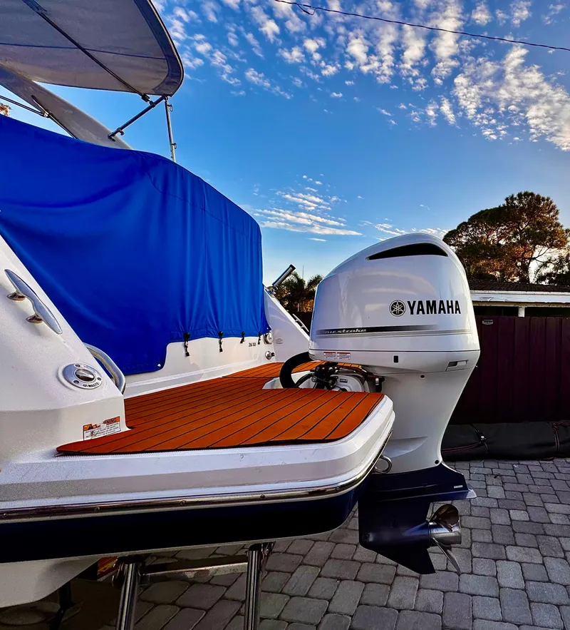 Slide: The Image of 2020 Regal 26XO boat with Yamaha outboard motor, docked under a blue sky. - 9