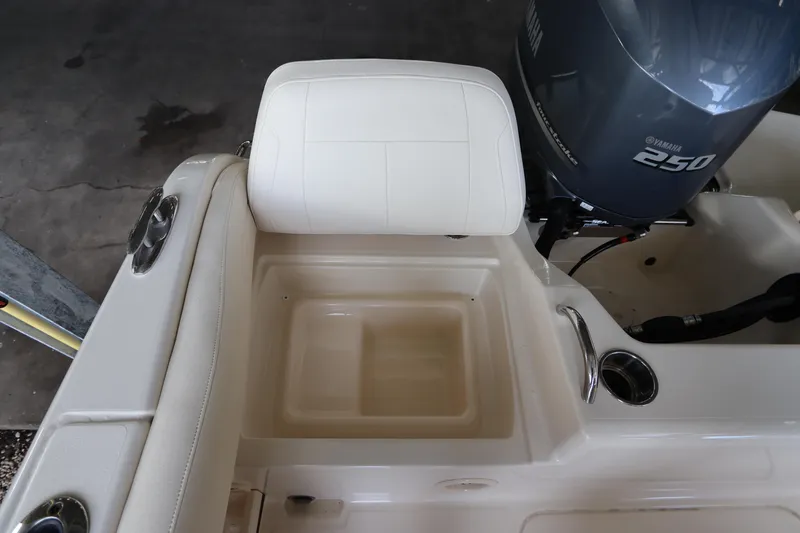 Slide: The Image of 2024 Grady-White Fisherman 216 boat with Yamaha 250 engine, featuring a cushioned seat and storage compartment. - 10