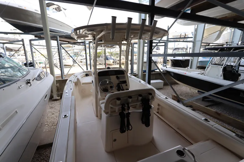 Slide: The Image of 2024 Grady-White Fisherman 216 boat in storage, showcasing helm and seating area. - 12