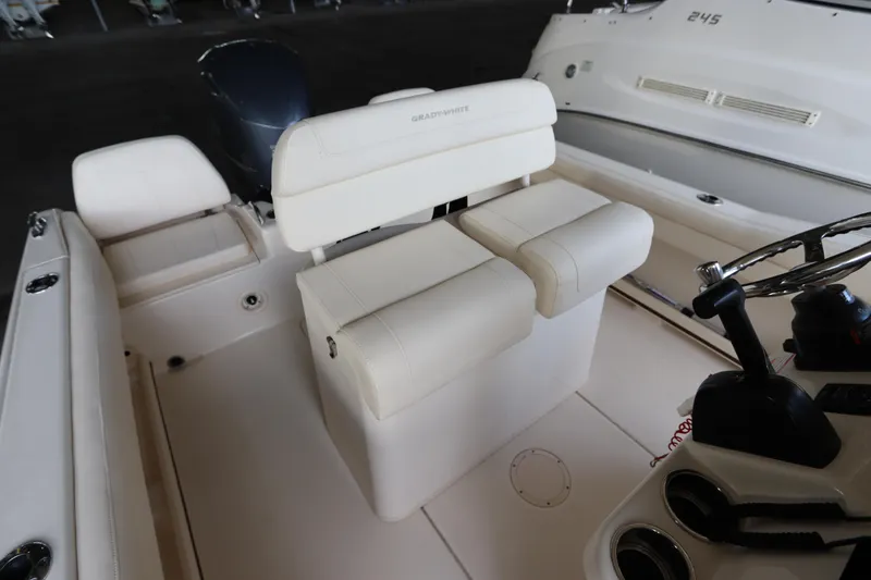 Slide: The Image of 2024 Grady-White Fisherman 216 boat interior with white seating and steering console. - 17
