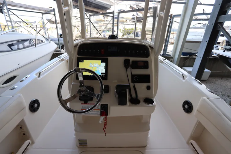 Slide: The Image of 2024 Grady-White Fisherman 216 boat console with steering wheel and navigation system. - 19