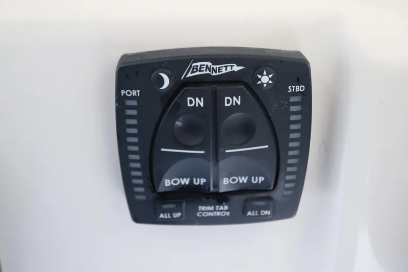 Slide: The Image of Bennett trim tab control on 2024 Grady-White Fisherman 216 boat dashboard. - 21