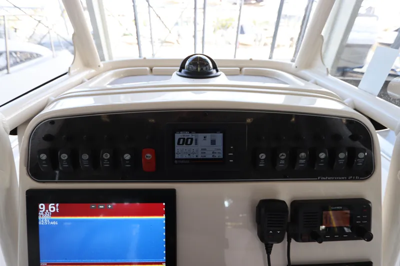 Slide: The Image of 2024 Grady-White Fisherman 216 dashboard with navigation and control systems. - 22
