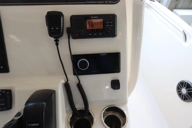 Slide: The Image of 2024 Grady-White Fisherman 216 dashboard with Garmin radio and Yamaha controls. - 27