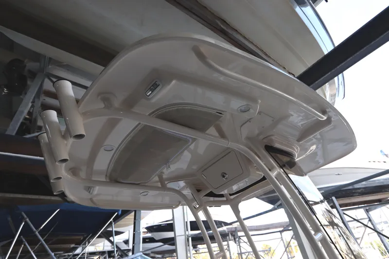 Slide: The Image of 2024 Grady-White Fisherman 216 boat's T-top structure in a marina setting. - 36