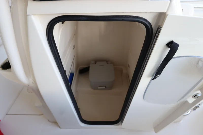 Slide: The Image of 2024 Grady-White Fisherman 216 boat storage compartment with open door. - 38