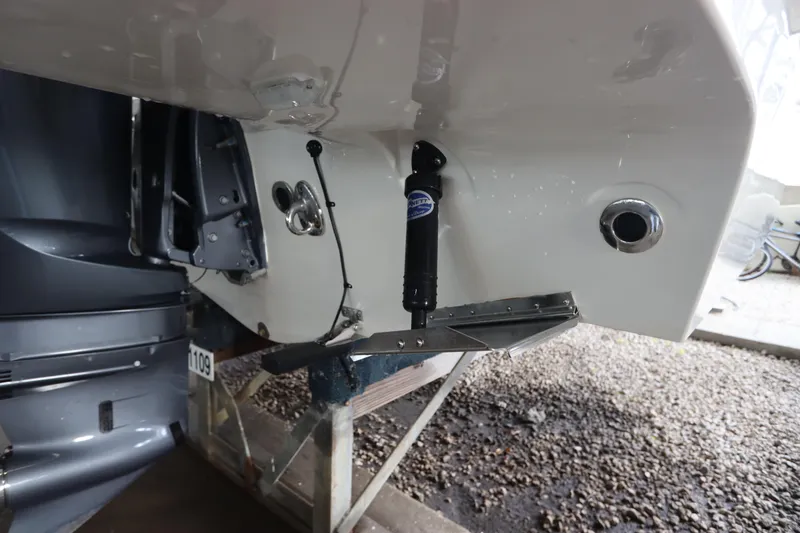 Slide: The Image of 2024 Grady-White Fisherman 216 boat transom with trim tabs and outboard motor. - 7