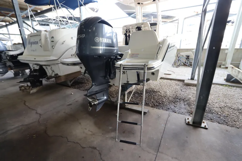 Slide: The Image of 2024 Grady-White Fisherman 216 with Yamaha outboard motor in a boat storage area. - 8