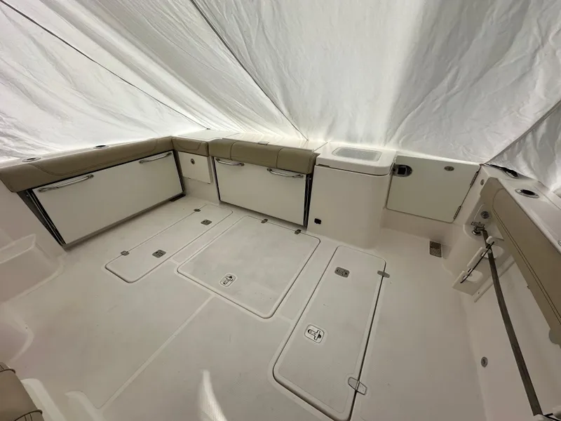 Slide: The Image of 2017 Pursuit OS 355 Offshore boat interior with storage compartments and seating. - 11