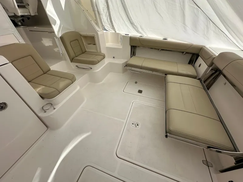Slide: The Image of 2017 Pursuit OS 355 Offshore boat interior with beige seating and spacious layout. - 14