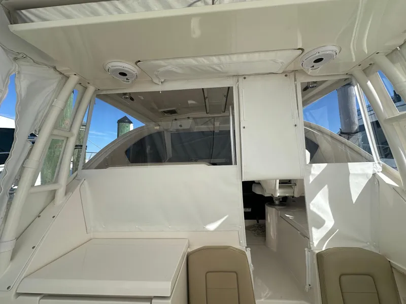 Slide: The Image of 2017 Pursuit OS 355 Offshore boat interior with seating and helm area. - 15