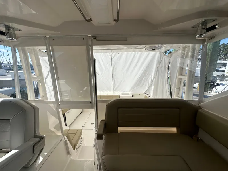 Slide: The Image of Interior view of 2017 Pursuit OS 355 Offshore boat with seating and windows. - 16