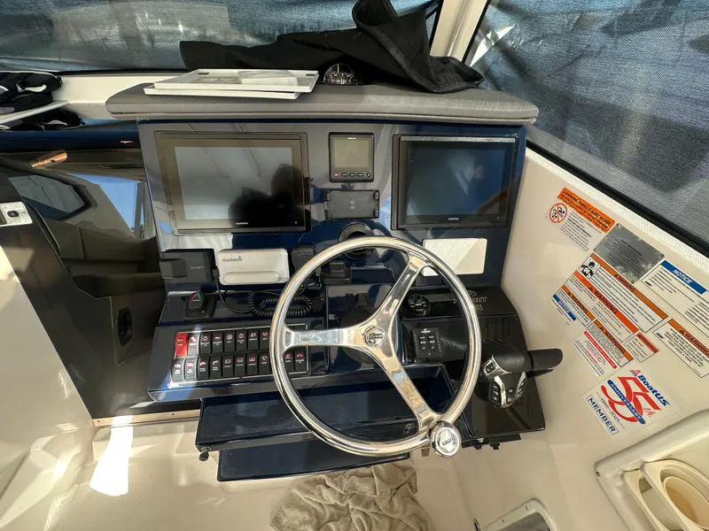 Slide: The Image of 2017 Pursuit OS 355 Offshore helm with dual displays and steering wheel. - 17