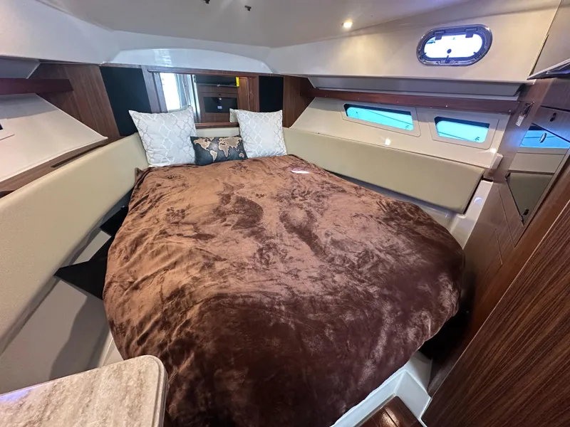 Slide: The Image of 2017 Pursuit OS 355 Offshore cabin with cozy bed and modern interior design. - 19