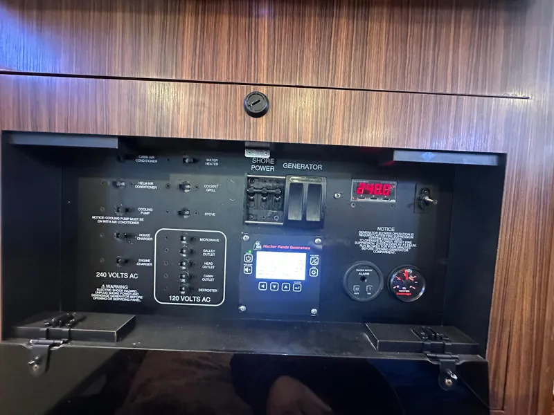 Slide: The Image of Control panel of a 2017 Pursuit OS 355 Offshore boat, featuring power switches and gauges. - 22