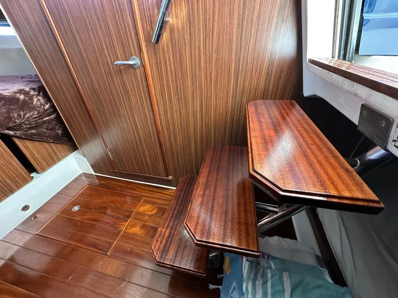Slide: The Image of Interior of 2017 Pursuit OS 355 Offshore with wooden steps and door. - 24