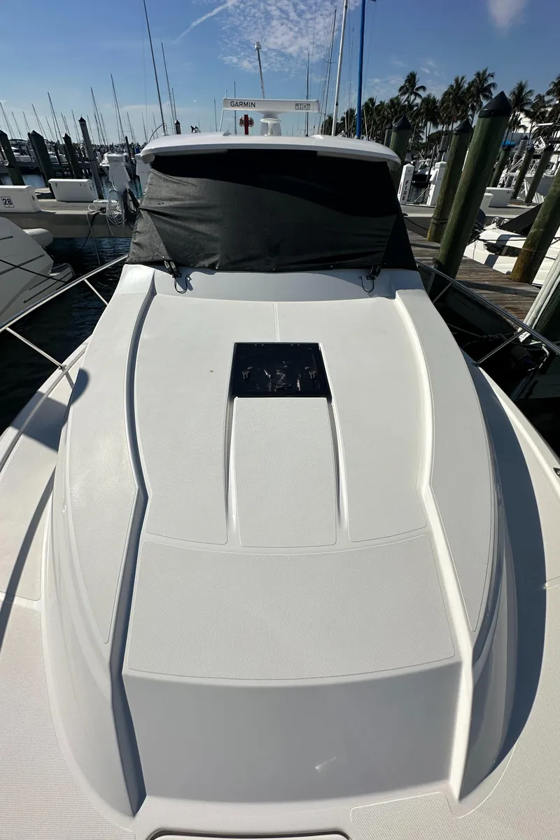 Slide: The Image of 2017 Pursuit OS 355 Offshore boat docked at marina under clear sky. - 29