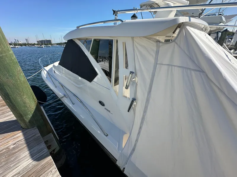 Slide: The Image of 2017 Pursuit OS 355 Offshore boat docked at marina. - 5