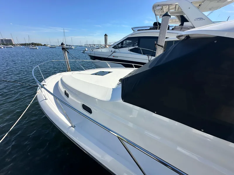 Slide: The Image of 2017 Pursuit OS 355 Offshore boat docked in a marina. - 7