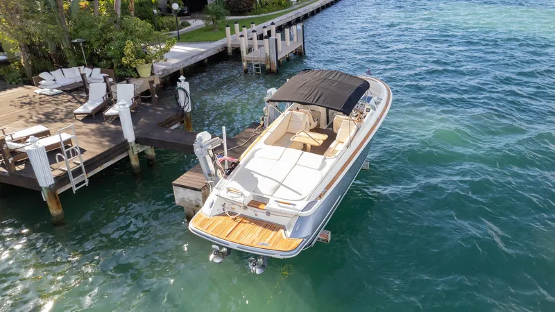 Slide: The Image of 2014 Chris-Craft Launch 32 boat docked on clear blue water. - 10