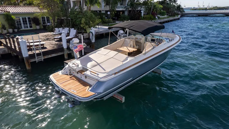 Slide: The Image of 2014 Chris-Craft Launch 32 boat docked on clear blue water. - 12