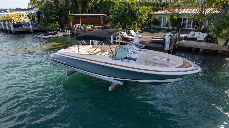 Slide: The Image of 2014 Chris-Craft Launch 32 boat docked by a waterfront home. - 13