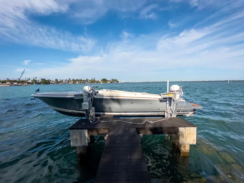 Slide: The Image of 2014 Chris-Craft Launch 32 boat docked on a wooden pier, ocean backdrop. - 16