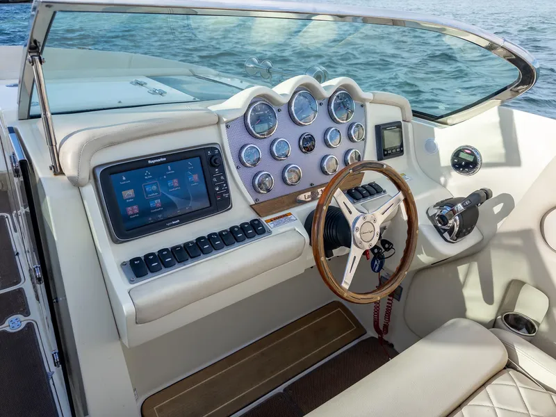 Slide: The Image of 2014 Chris-Craft Launch 32 dashboard with modern controls and wooden steering wheel. - 21