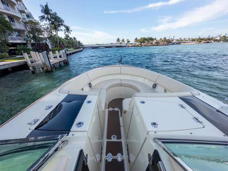 Slide: The Image of 2014 Chris-Craft Launch 32 boat on scenic waterfront with palm trees. - 23