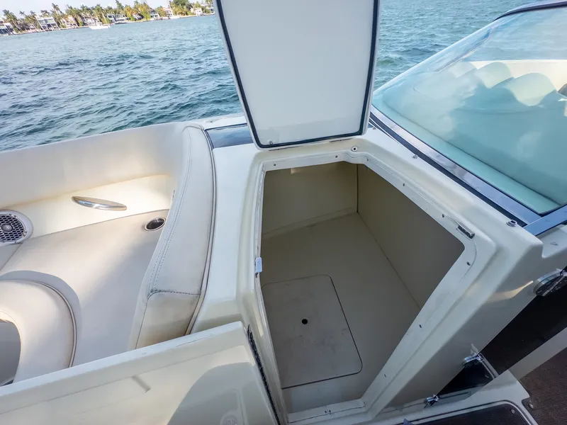 Slide: The Image of 2014 Chris-Craft Launch 32 boat with open storage compartment, near water. - 26