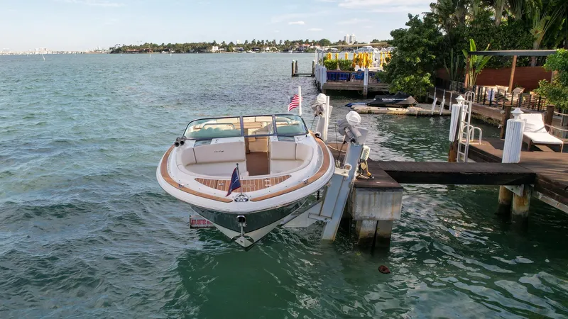 Slide: The Image of 2014 Chris-Craft Launch 32 docked by a scenic waterfront. - 3