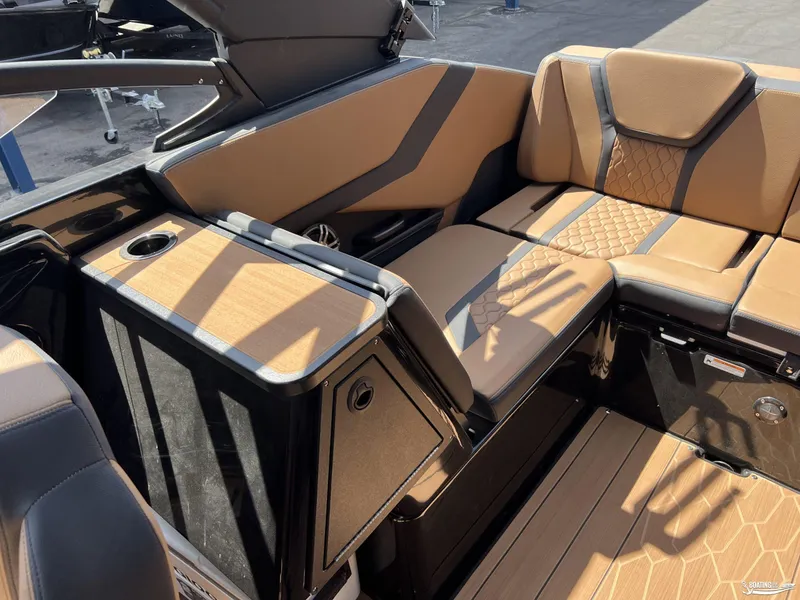 Slide: The Image of 2025 Yamaha Boats 255XD interior with tan seating and wood accents. - 15