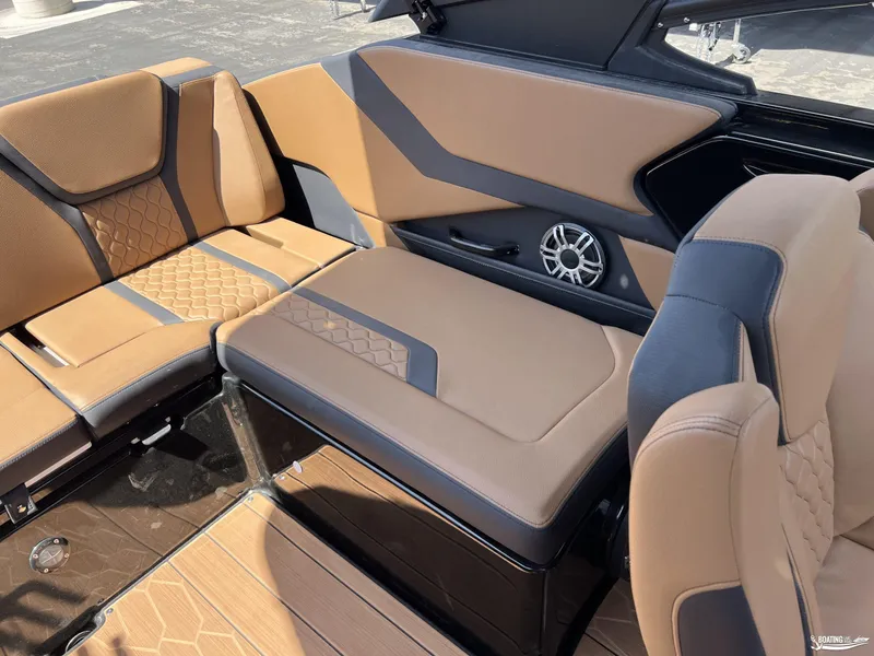 Slide: The Image of 2025 Yamaha Boats 255XD interior with tan and black seating, featuring modern design and speaker system. - 17