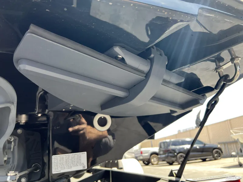 Slide: The Image of Close-up of 2025 Yamaha Boats 255XD hull detail in a parking lot. - 18