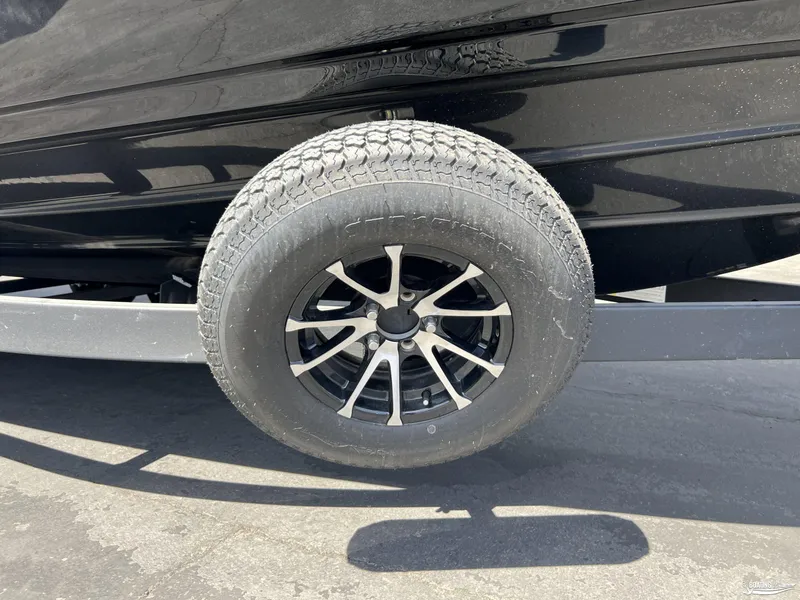 Slide: The Image of 2025 Yamaha Boats 255XD trailer wheel with black alloy rim. - 19