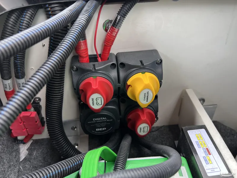 Slide: The Image of Electrical system components in a 2025 Yamaha Boats 255XD, featuring switches and wiring. - 24